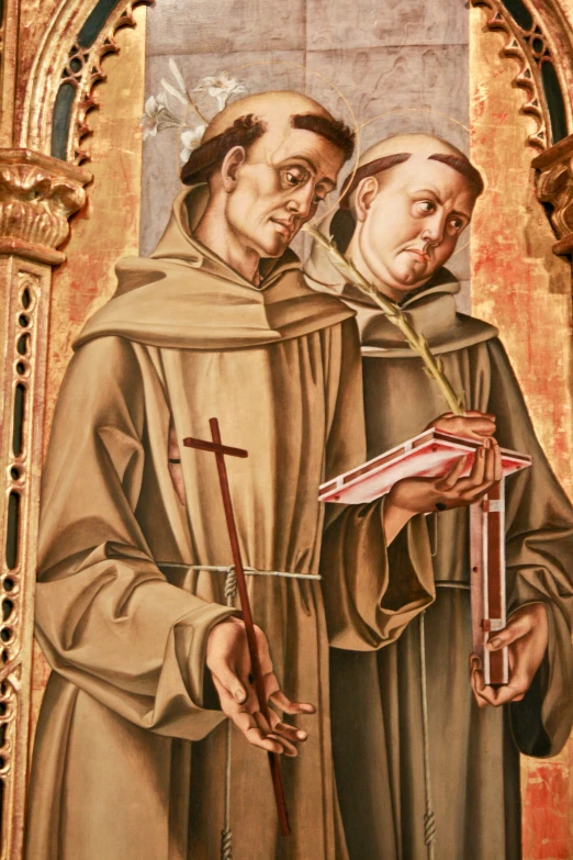 a painting of a saint and a monk holding a book