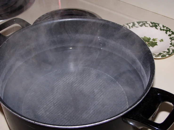 a black pan sitting on top of a stove top