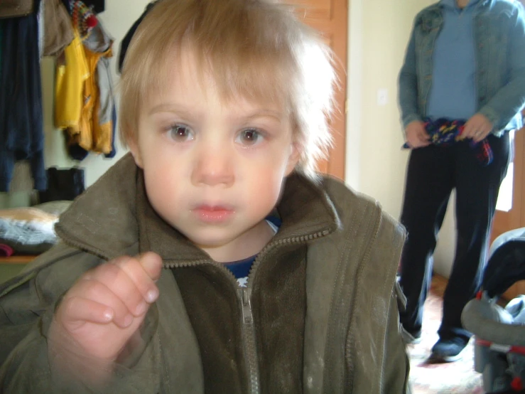 an older man standing next to a child in a clothing closet