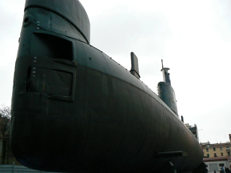 a black submarine is seen from the side