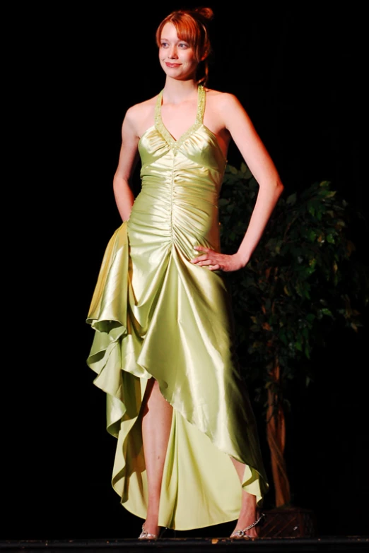 a woman is dressed in an elegant green dress