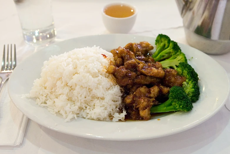 a close up of food on a plate near some silverware