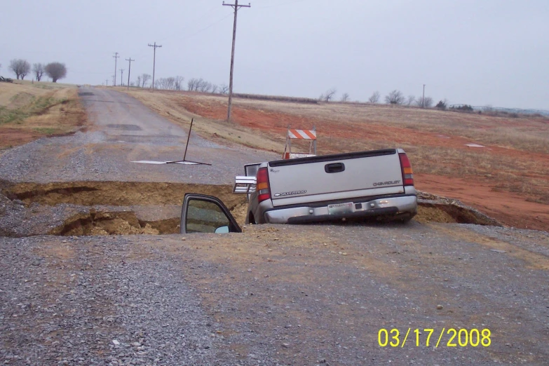 a pickup truck stuck in the side of a road