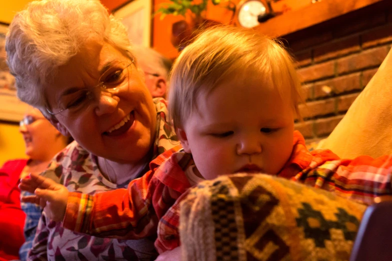 an older lady holds a child in her lap