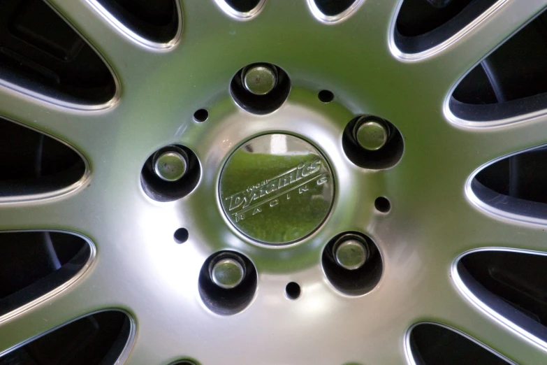 wheel of car parked with black tires and black spokes