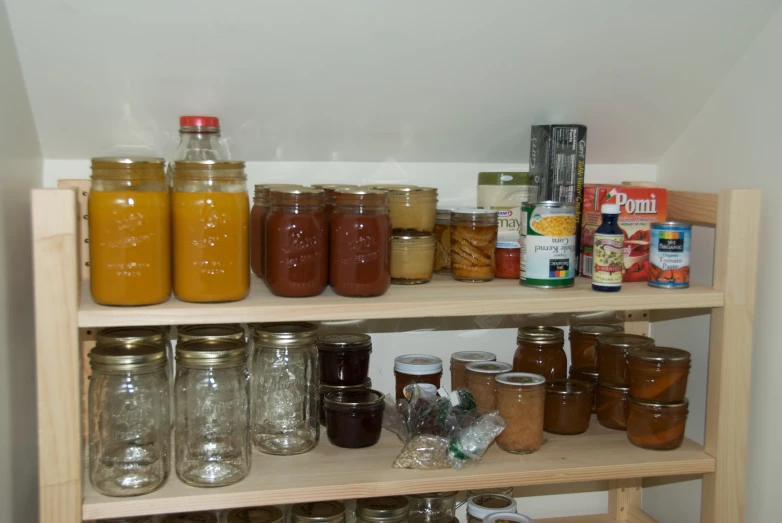 jars full of various foods and condiments on a shelf