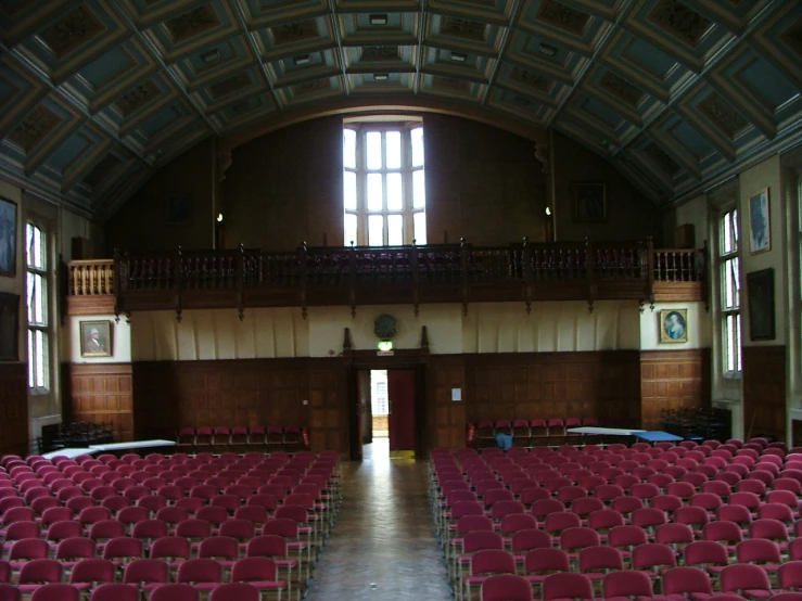 auditorium filled with red seats in large building