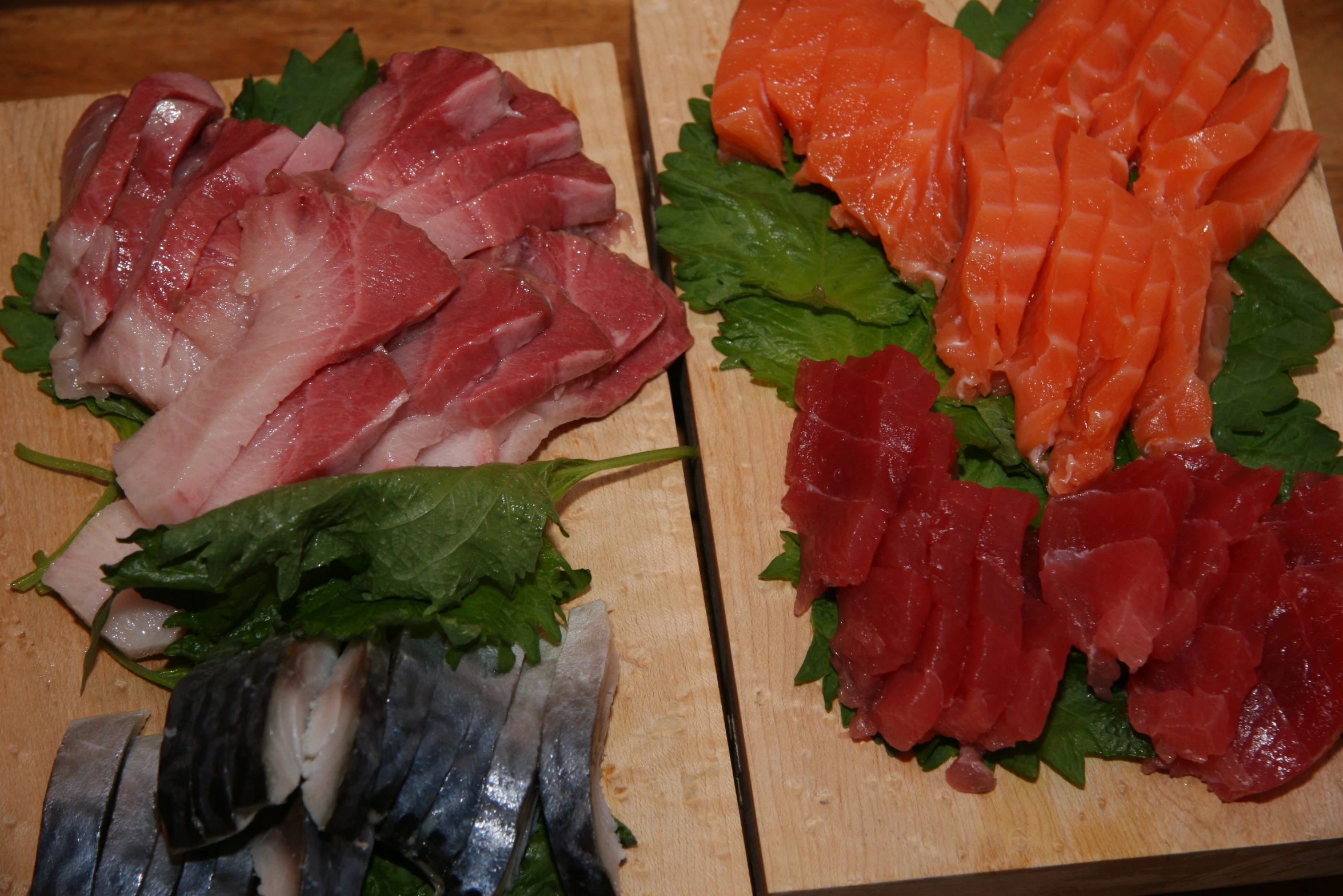 a wooden table filled with different types of sashi