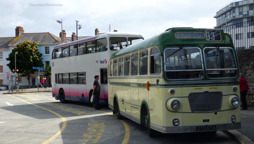 two double decker buses parked on the side of the road