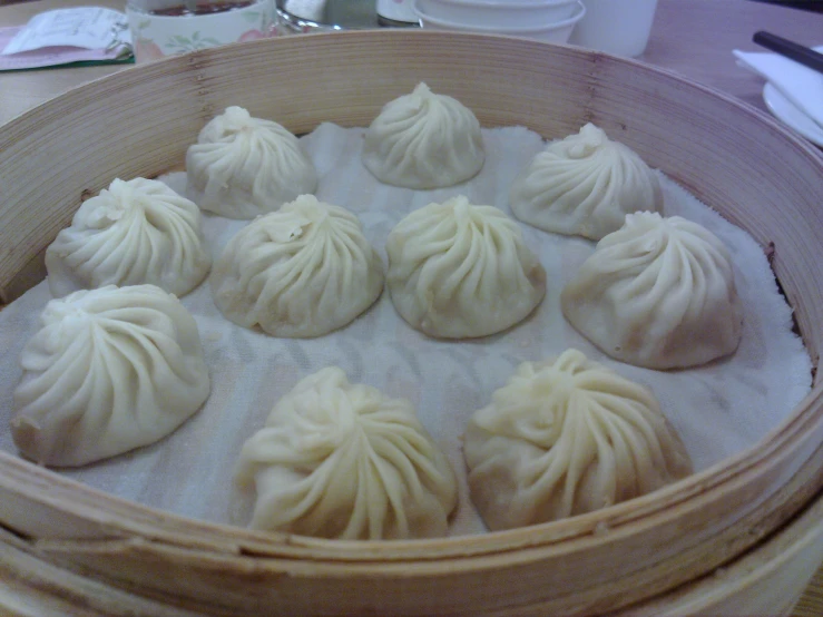 a bamboo steamer is holding dumplings in it