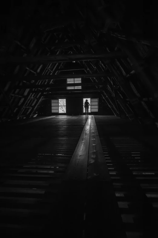 the inside of a dark room with wooden beams