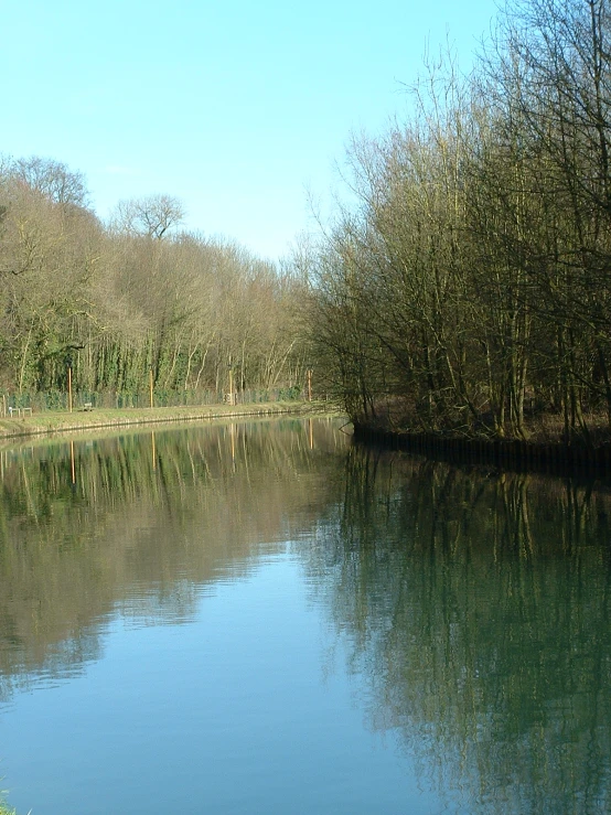 a long stretch of water with a body of water surrounded by trees