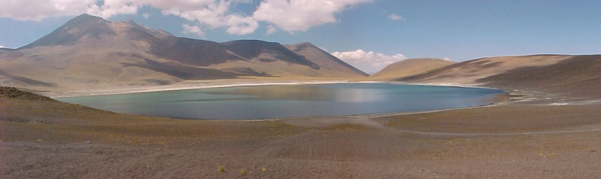 a beautiful blue lagoon in the middle of a mountain range