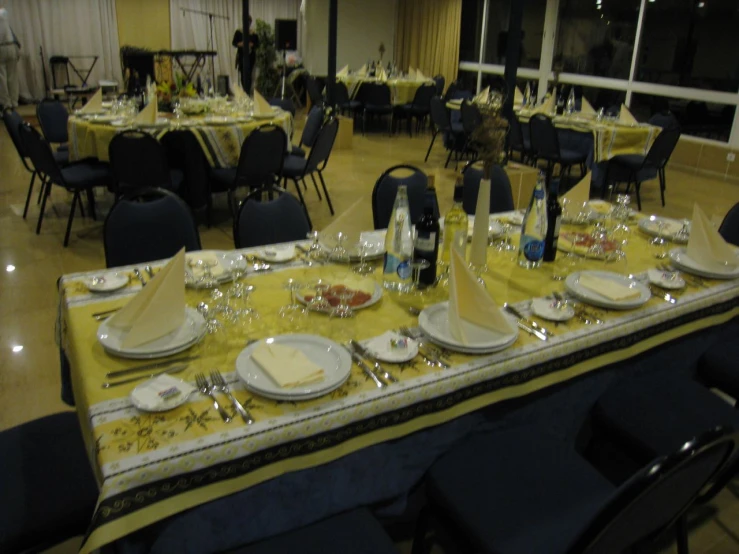 a dining room has a long table and blue chairs