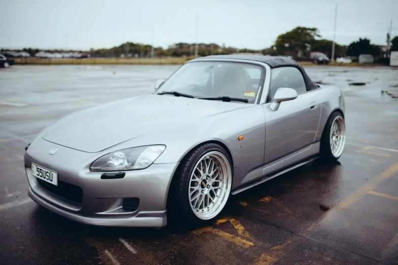 a silver sports car parked in a parking lot