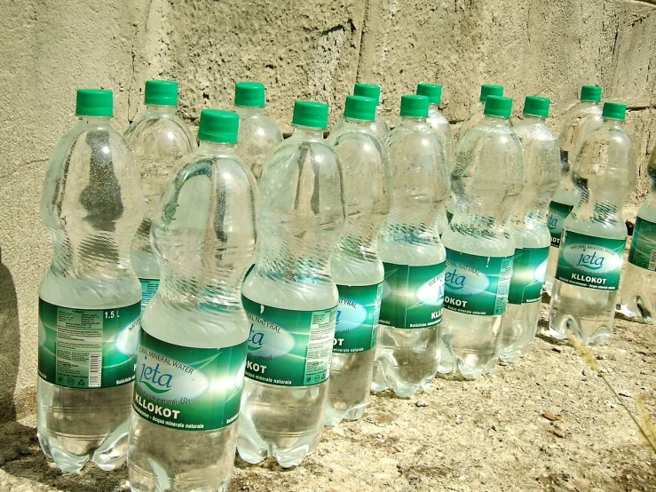 a group of bottles of water are lined up