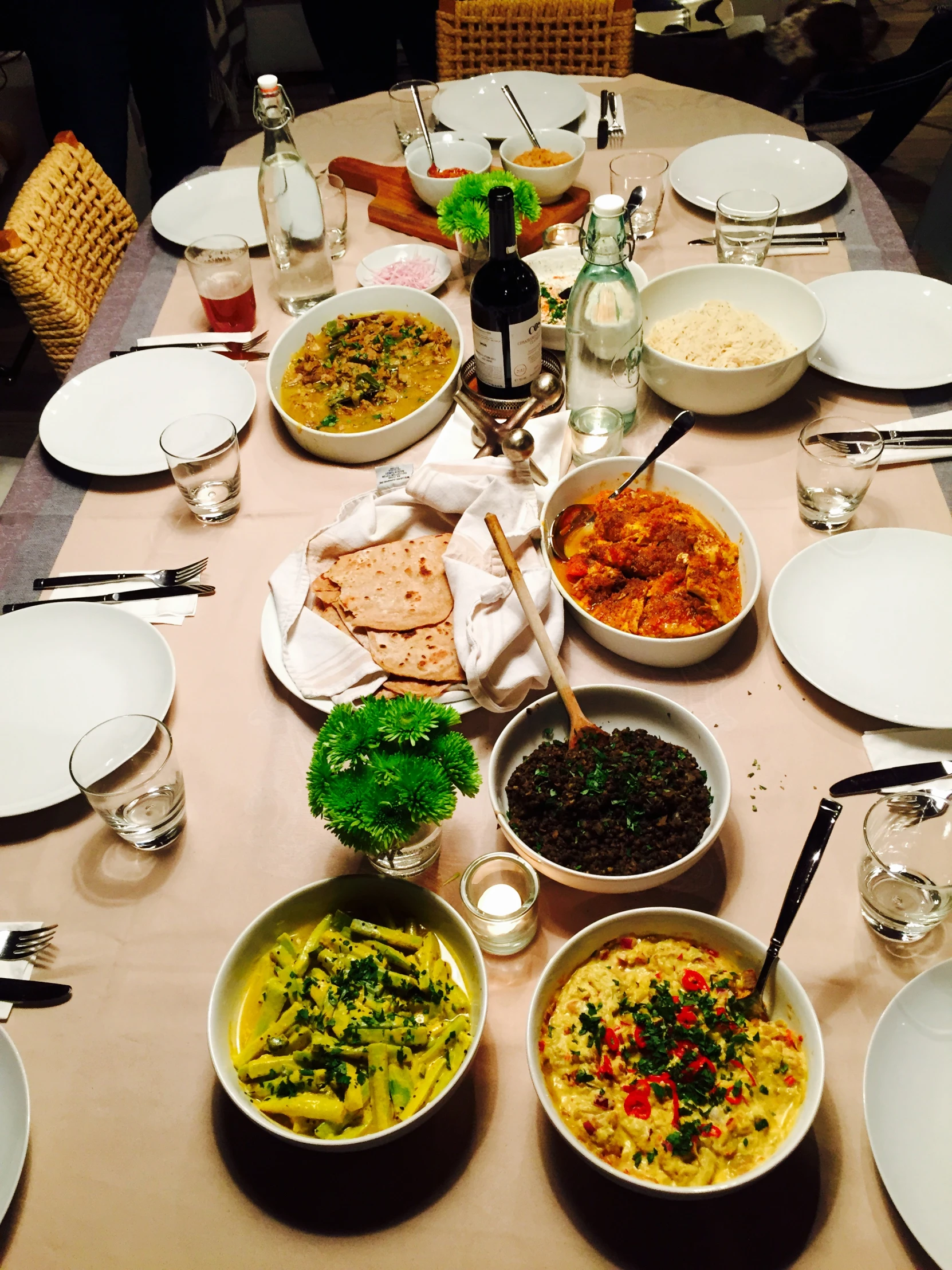 a table filled with plates, bowls and bowls full of food