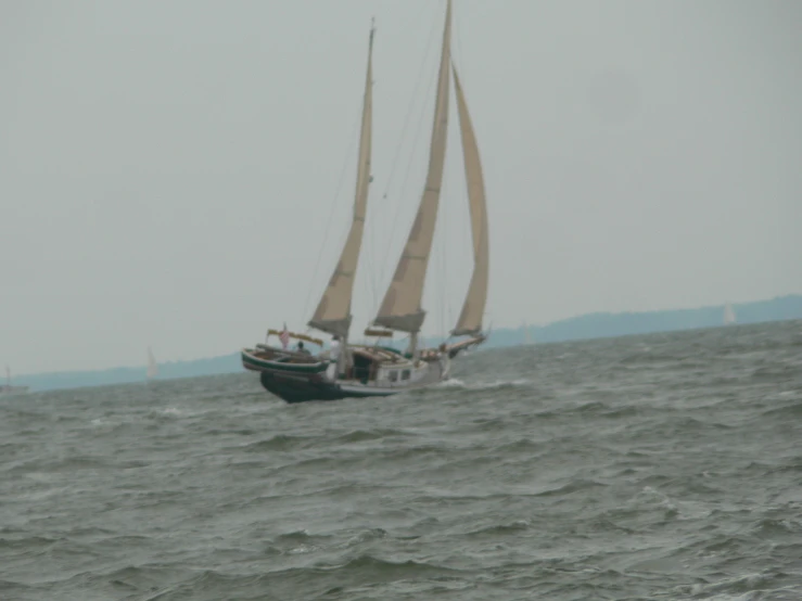 a small sailboat floating on top of water