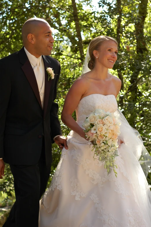 a bride and groom walking next to each other