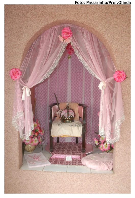 a miniature pink bedroom with a white chair in it