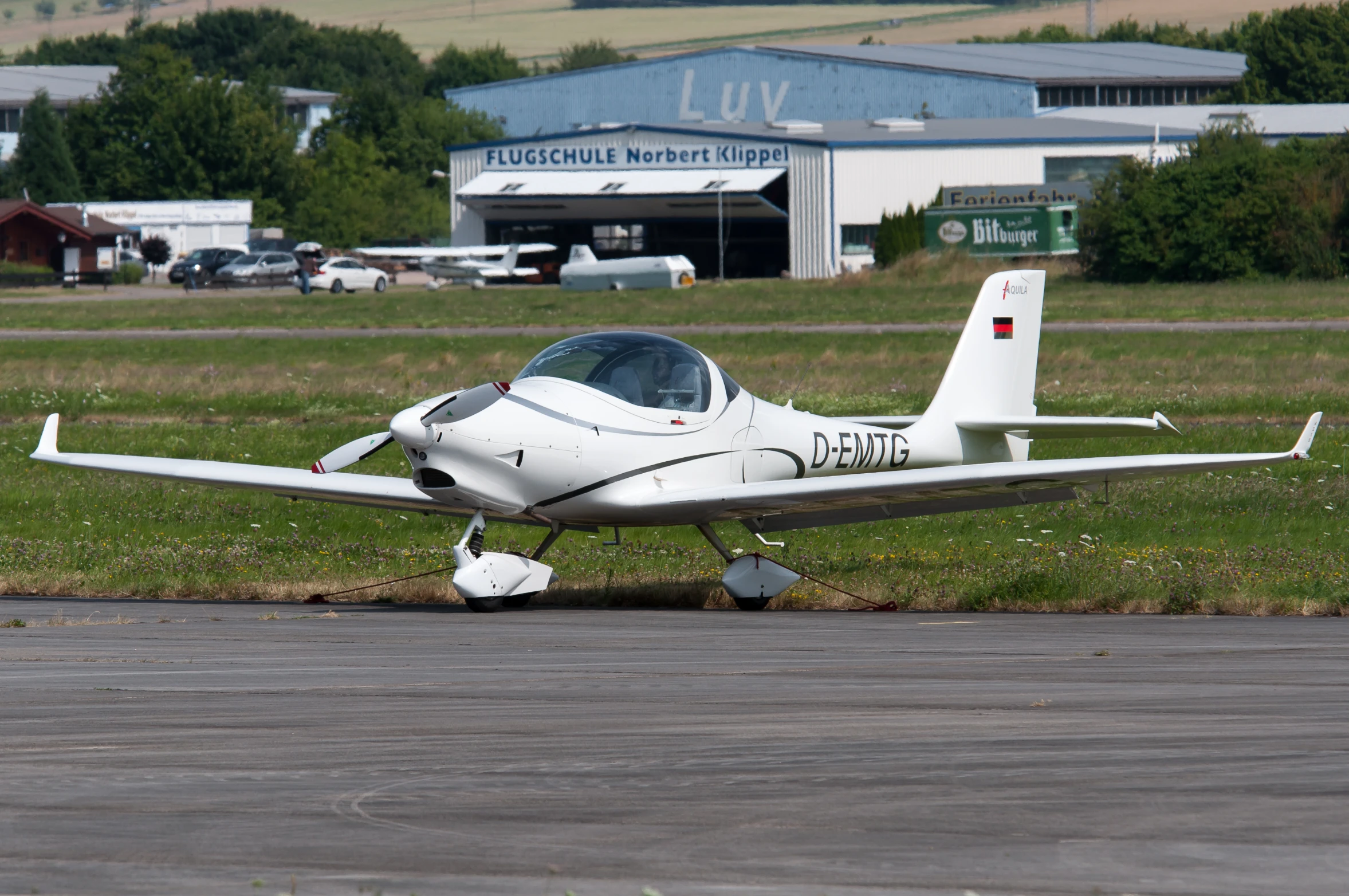 a small private plane on a runway near an airport