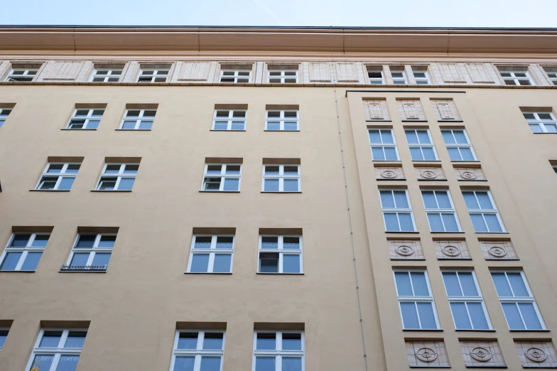 a tall brown building has lots of windows