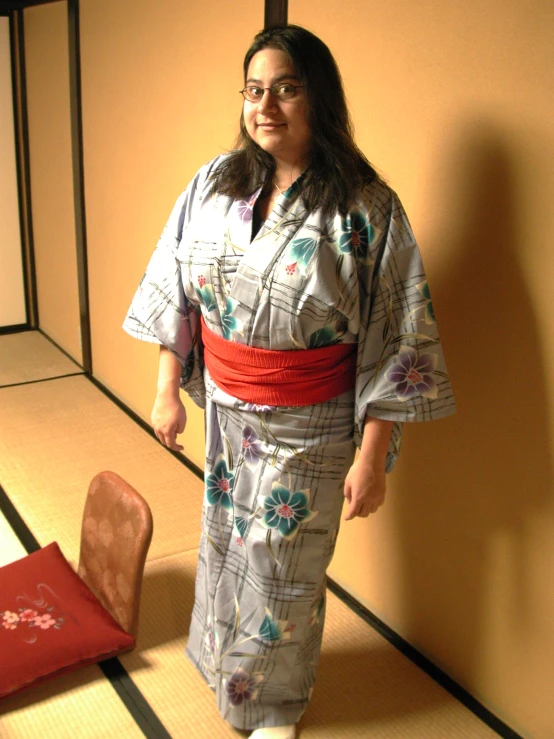 a woman stands in an oriental style outfit