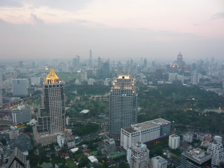 a city skyline showing skyscrs with golden top lights