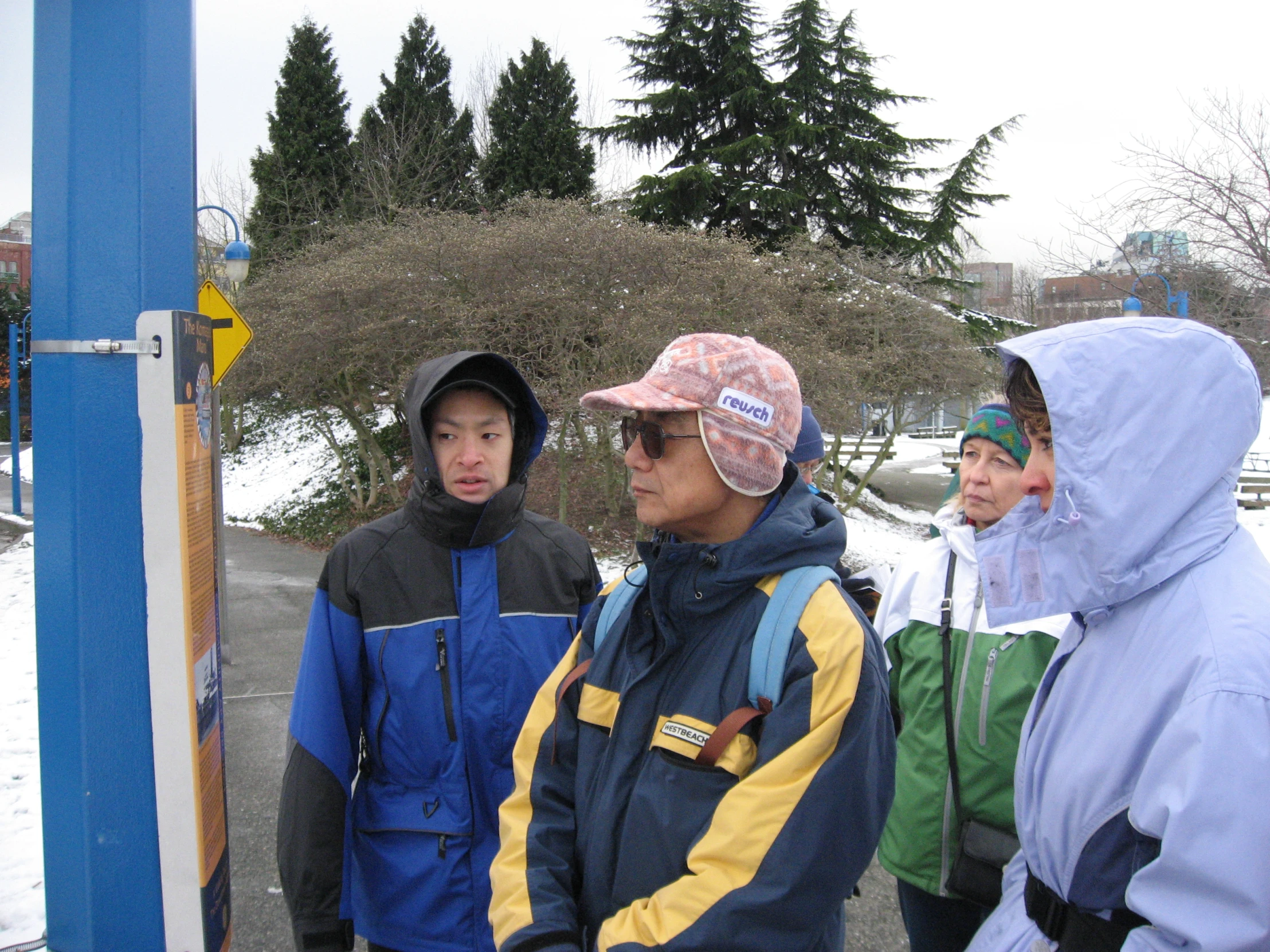 a group of people are standing on a snowy day