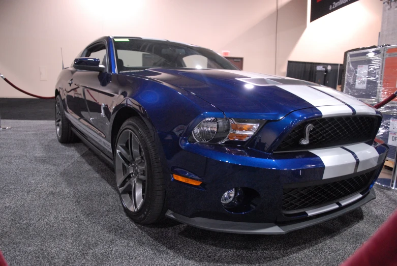 a blue car is on display in the showroom