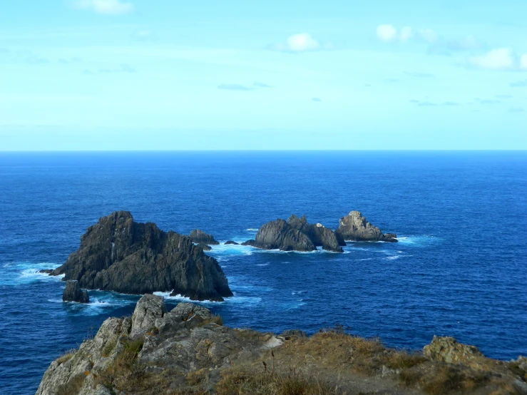 several different rocks on the ocean and in the middle