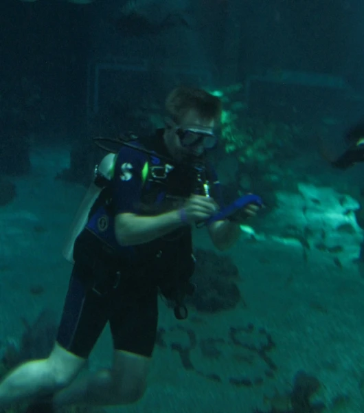 a man scubas next to another diver in the water