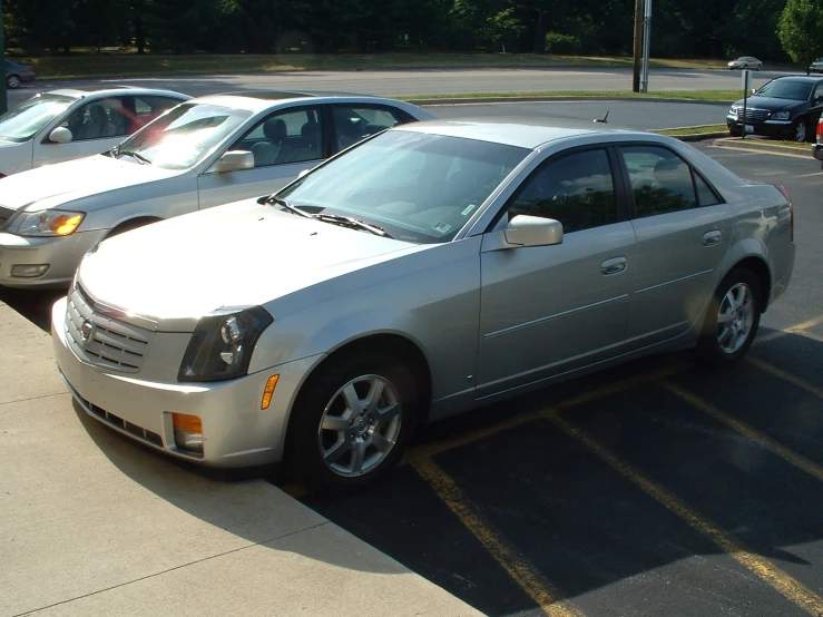 an image of three cars that are parked in the parking lot