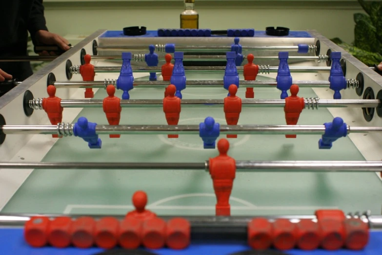 foosball tables filled with red and blue foosball figures