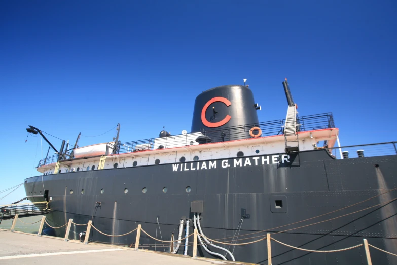 a large black ship parked on the water