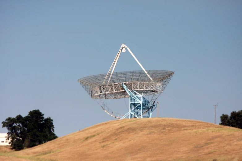 a large satellite dish sitting on top of a hill