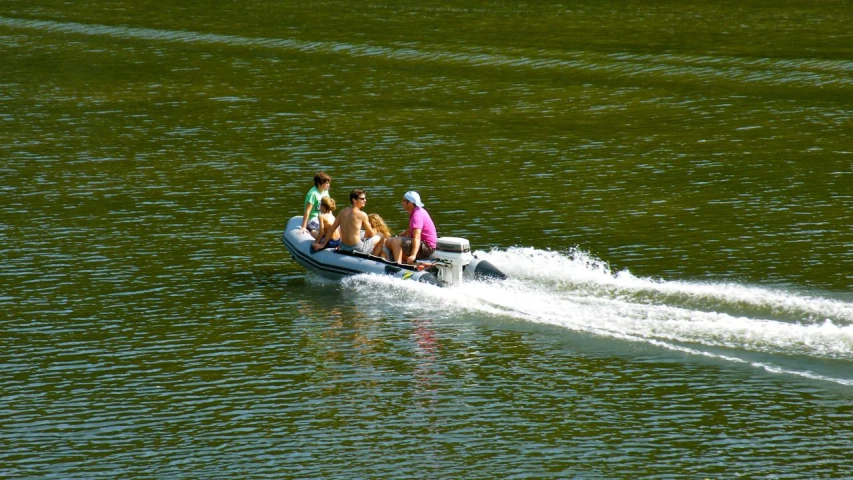 four women riding on the back of a small boat