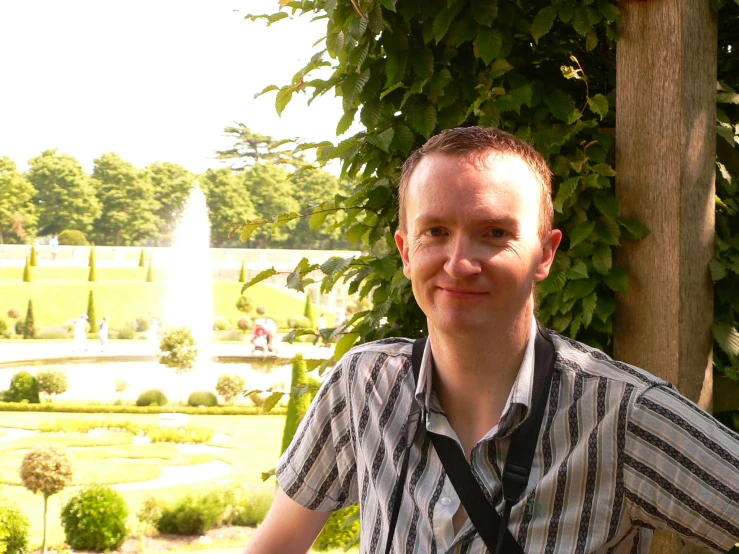 a man standing in front of a fountain