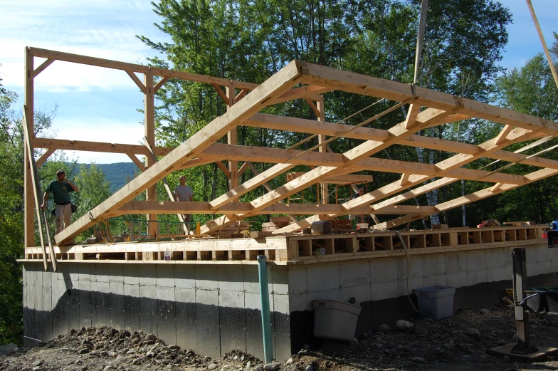 a man on top of a wooden roof