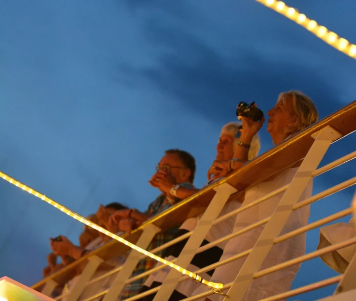 some people are standing on a white railing