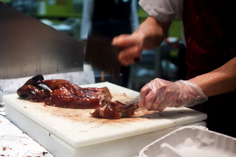 a chef slicing ribs with a knife