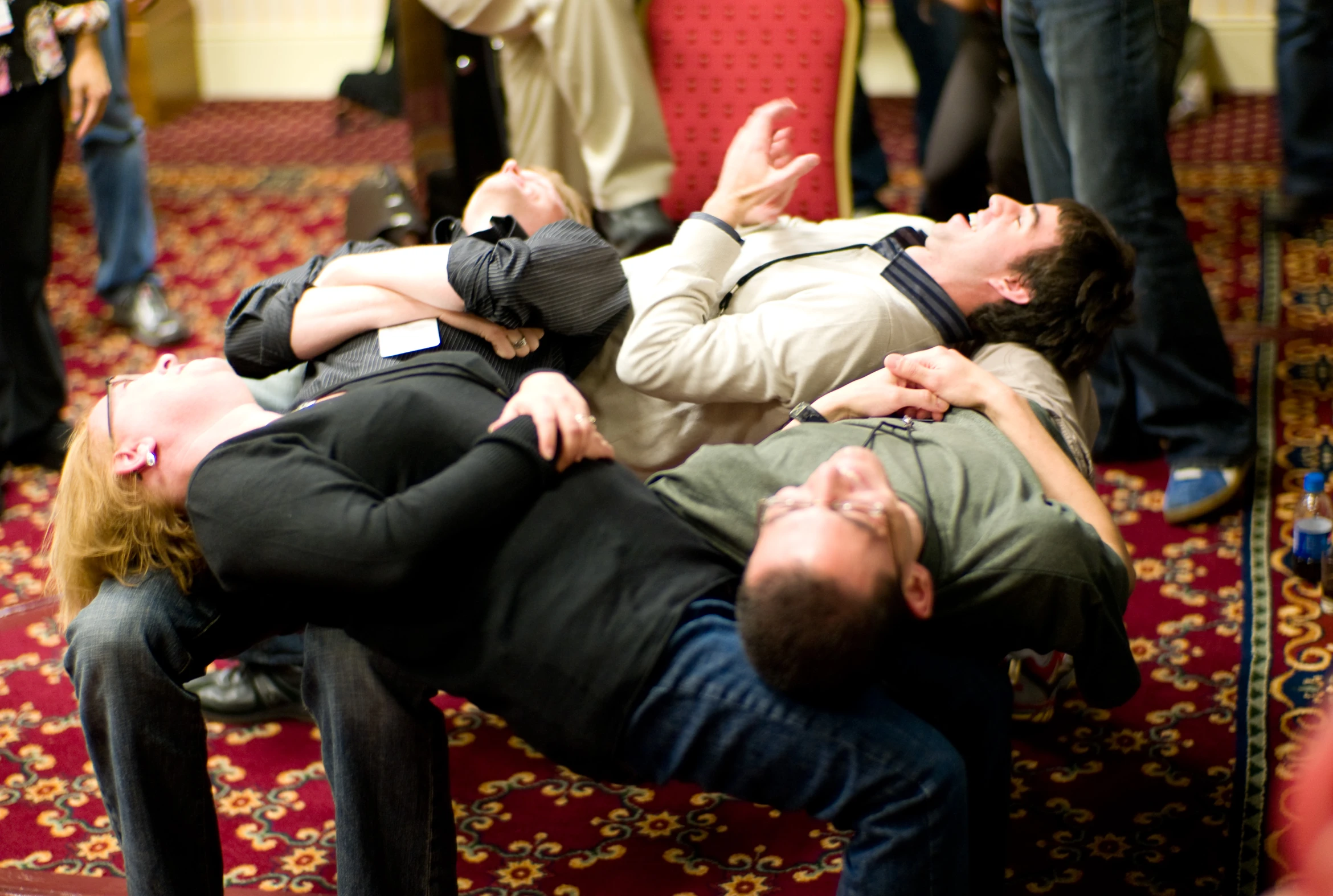 a group of people laying in a room with some one holding the woman