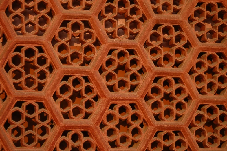 a decorative structure made of honeycombs and orange sticks