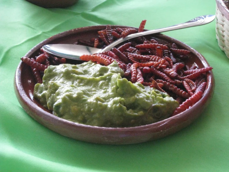 a bowl with a spoon sitting in it and there are various foods