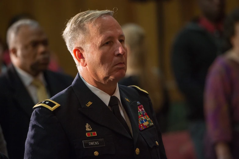 two men in military clothing standing next to each other