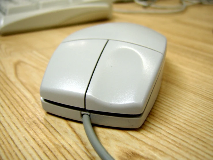 a silver computer mouse on a wooden table