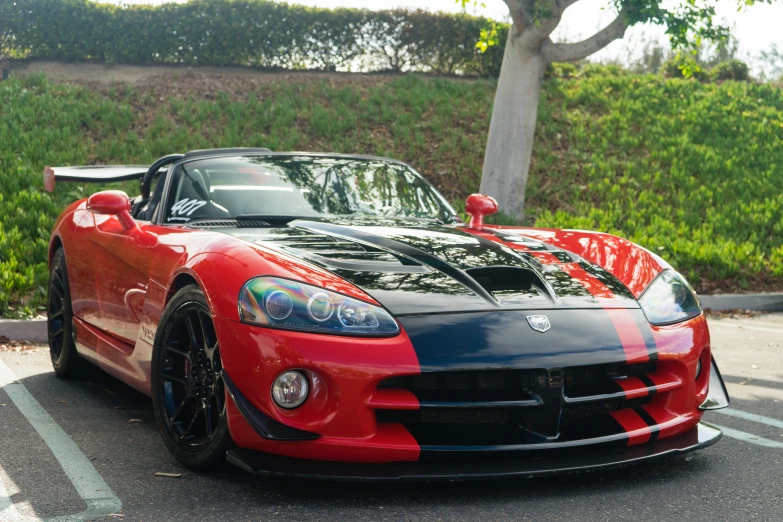 a red sports car with some black stripe paint job