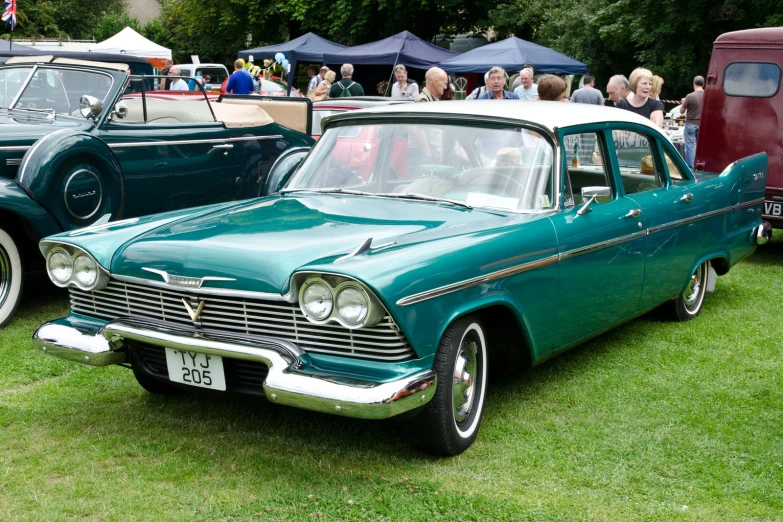 vintage green station wagon on display at a car show