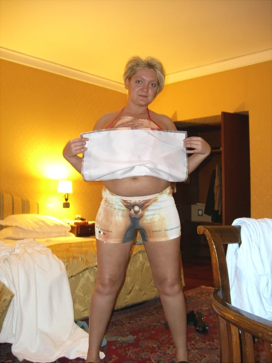 a woman is posing with white towels around her waist