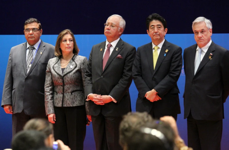 a group of men standing in front of a microphone